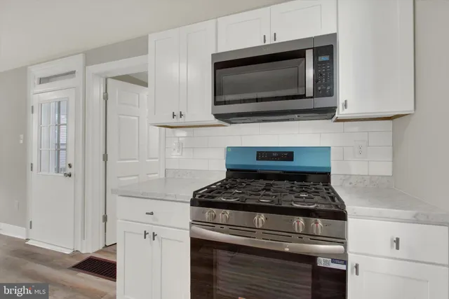 a kitchen with cabinets stainless steel appliances and a counter space