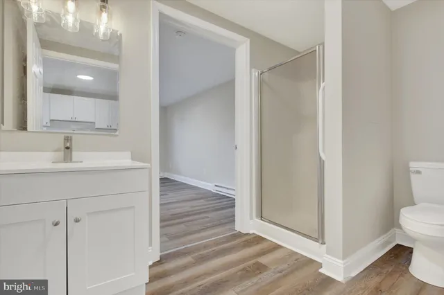 a bathroom with a sink mirror and toilet