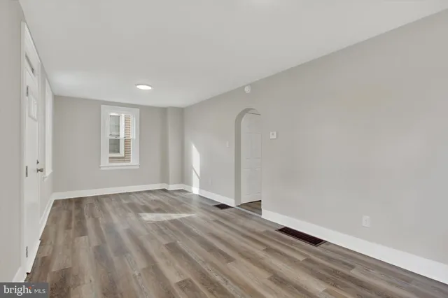 a view of a room with wooden floor