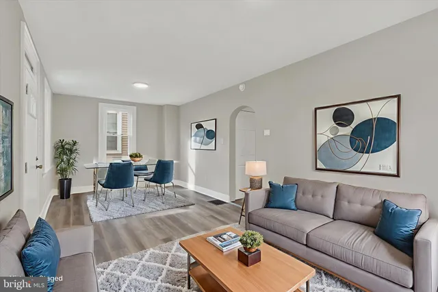 a living room with furniture and wooden floor