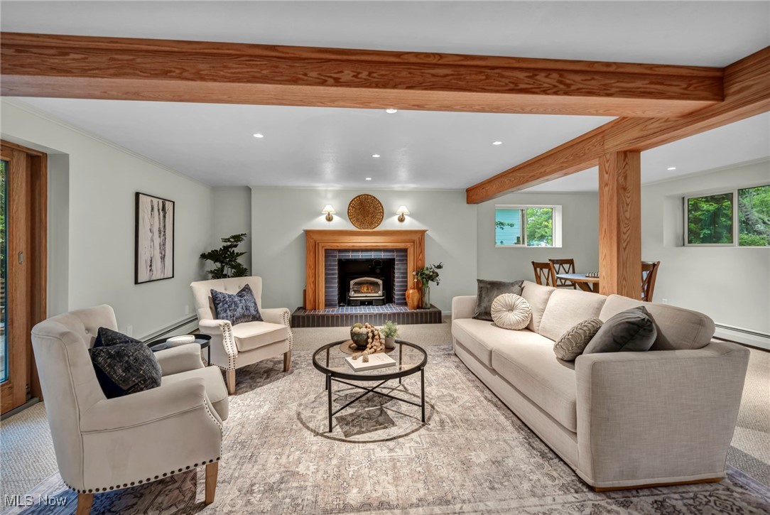 13962 Quarry Road Oberlin, OH 44074 - Photo 16 of 43 Living room featuring beam ceiling, recessed lighting, healthy amount of natural light, baseboard heating, and a custom warming fireplace