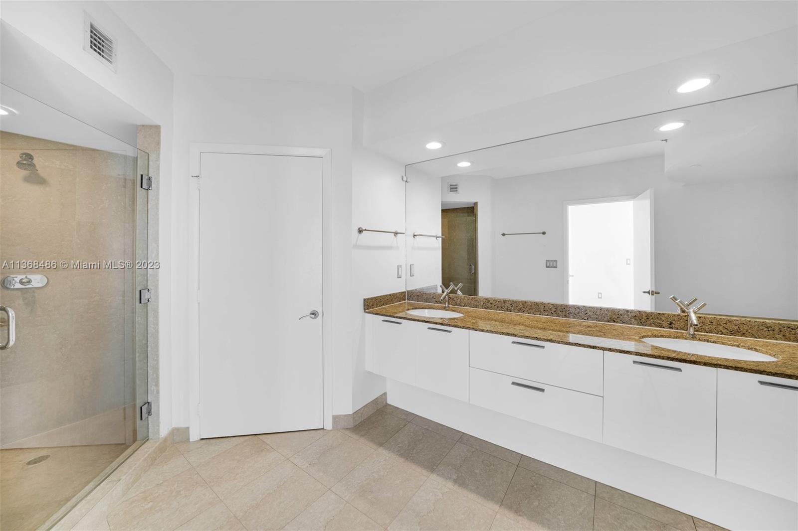 400 Alton Road, Unit 2002 Miami Beach, FL 33139 - Photo 13 of 25 a large bathroom with a granite countertop sink and a mirror
