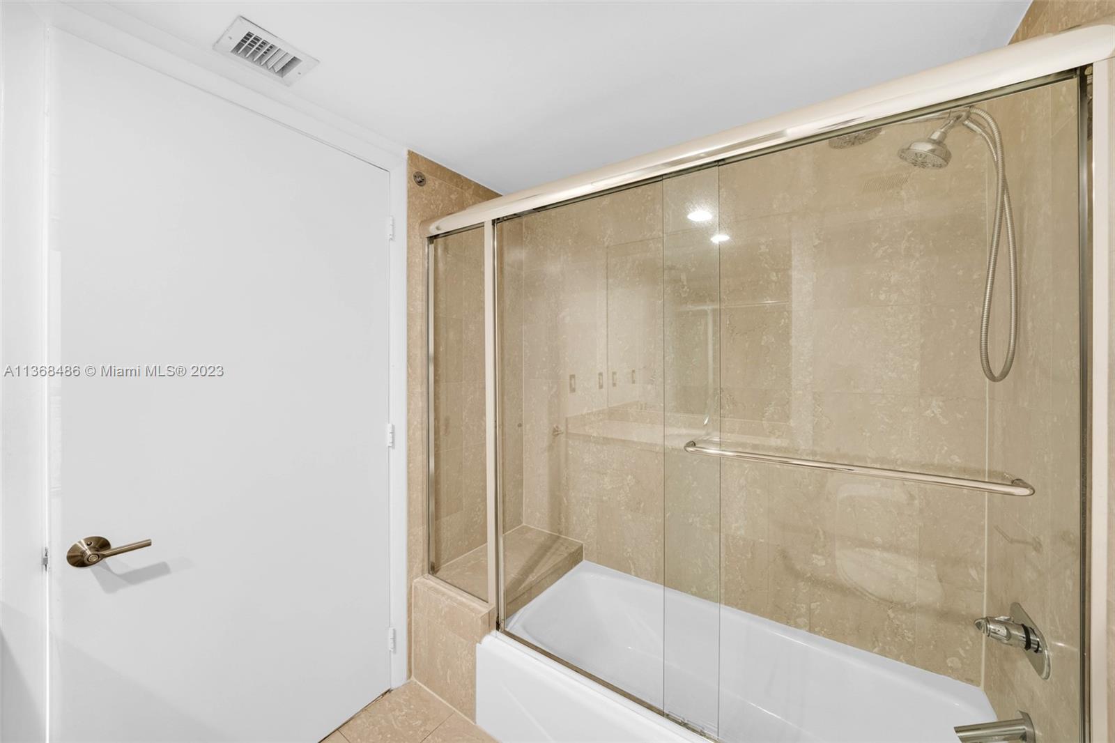 400 Alton Road, Unit 2002 Miami Beach, FL 33139 - Photo 18 of 25 a bathroom with a shower and a tub