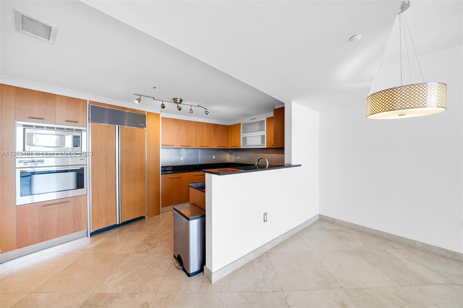 400 Alton Road, Unit 2002 Miami Beach, FL 33139 - Photo 7 of 25 a view of an empty room with a kitchen