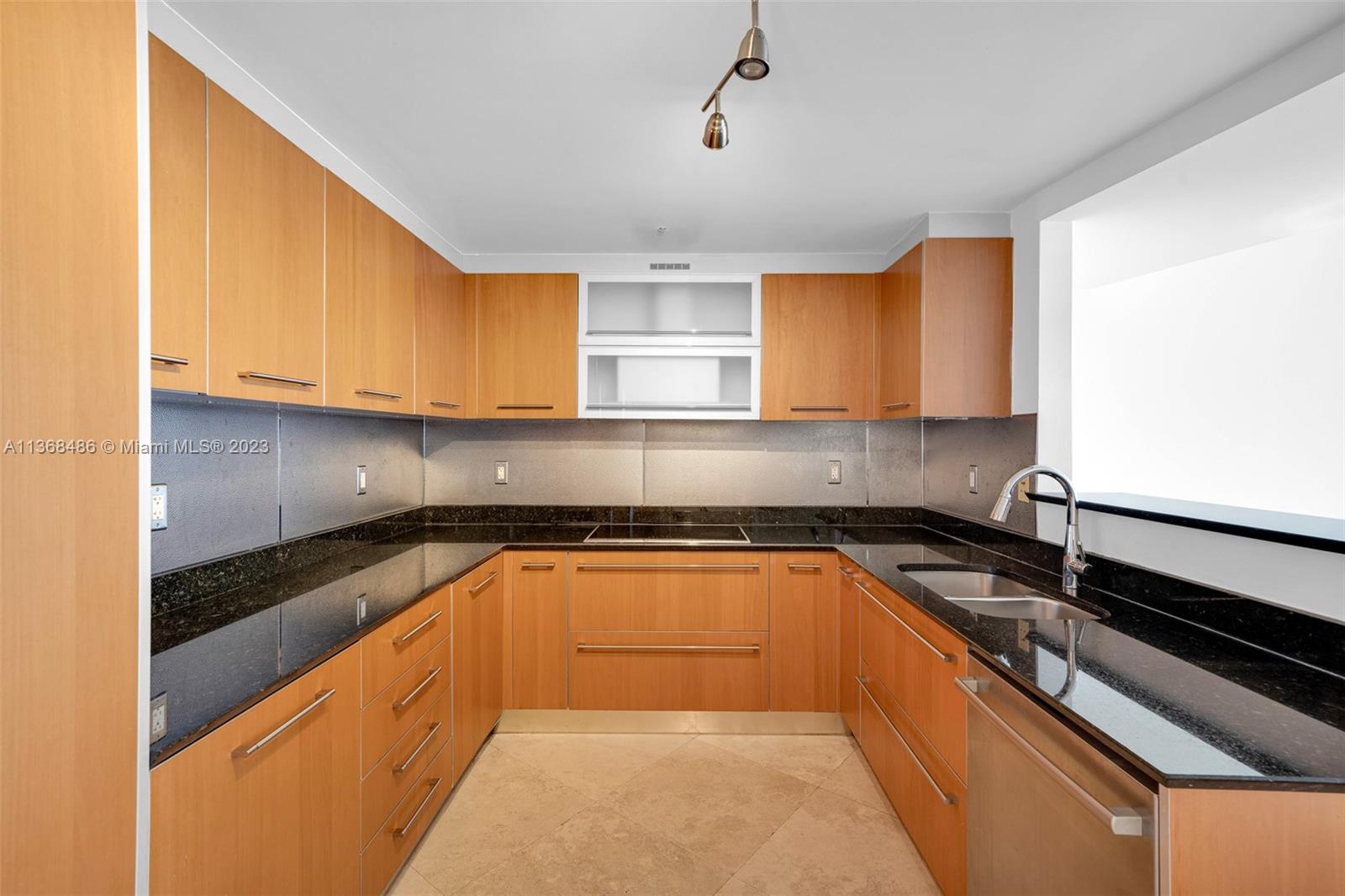400 Alton Road, Unit 2002 Miami Beach, FL 33139 - Photo 8 of 25 a kitchen with granite countertop a sink and a stove