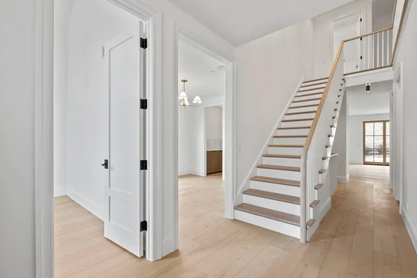 a view of a hallway with windows and stairs