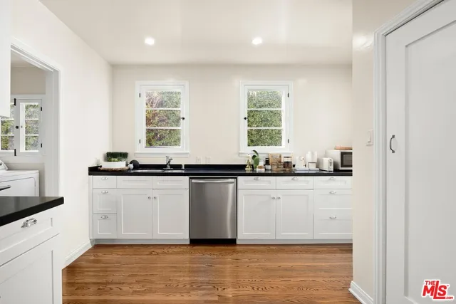 a view of a room with wooden floor and large window