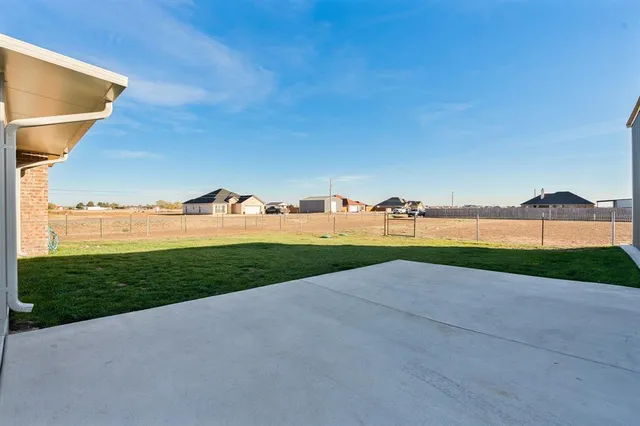 a view of a grassy area with an ocean view