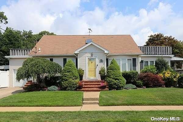 57 Henry Road Merrick, NY 11566 - Photo 1 of 1 a front view of a house with a yard