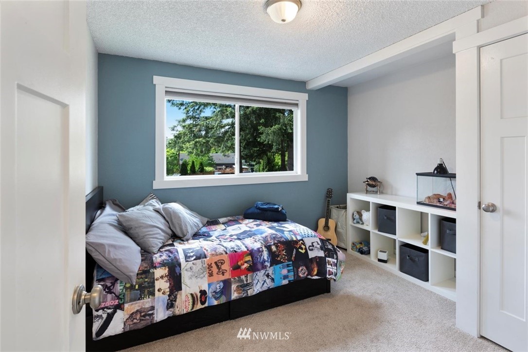 1227 207th Street Southeast Bothell, WA 98012 - Photo 22 of 39 a bedroom with bed and a window