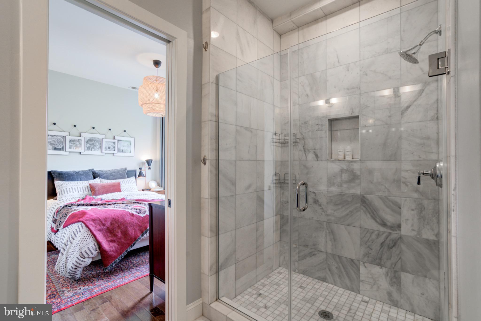 1249 Kenyon Street Northwest, Unit 2 Washington, DC 20010 - Photo 12 of 22 Elegant marble shower with serene bedroom view.