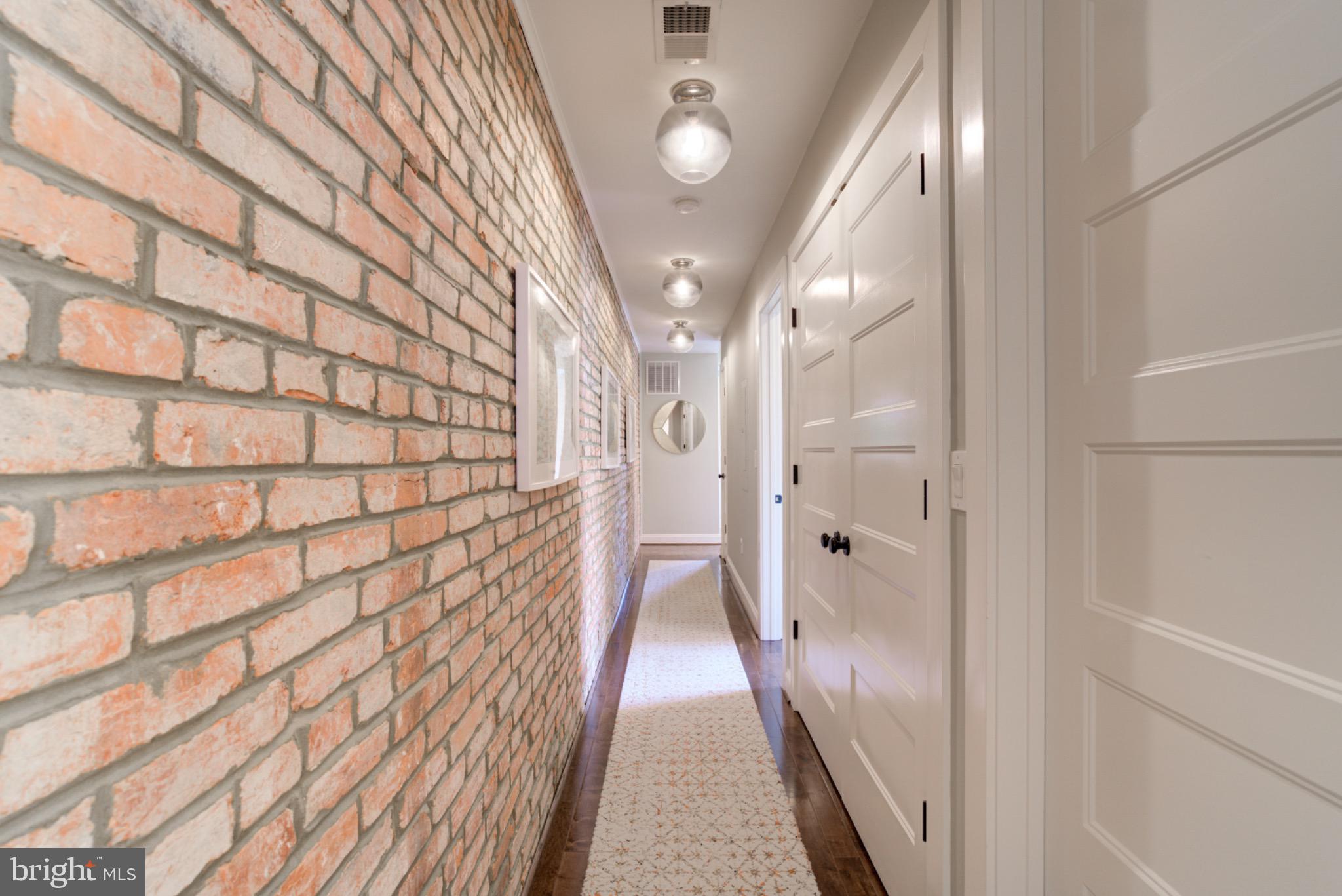 1249 Kenyon Street Northwest, Unit 2 Washington, DC 20010 - Photo 17 of 22 Charming hallway with exposed brick accents.