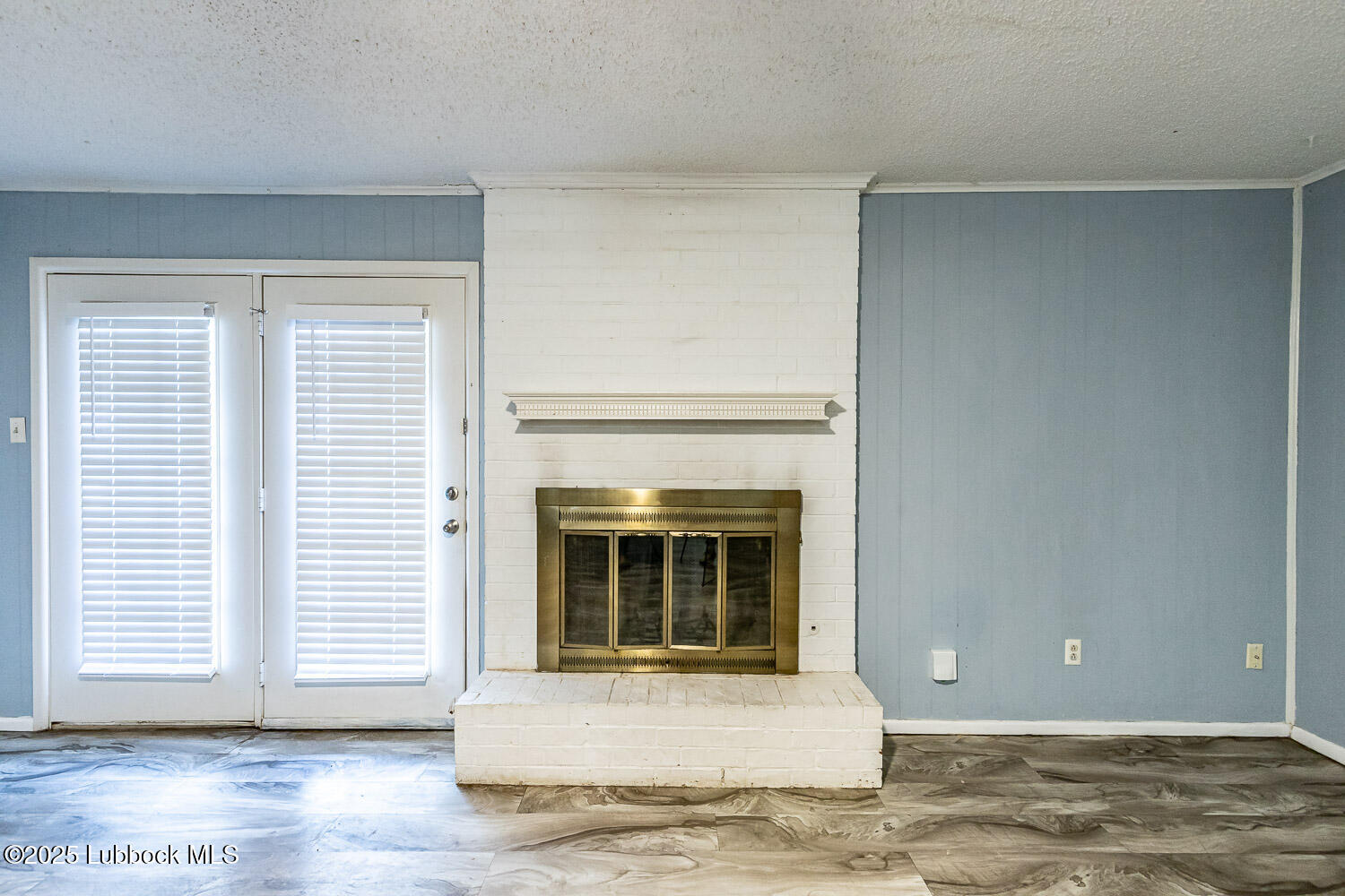 4305 52nd Street, Unit A Lubbock, TX 79413 - Photo 12 of 38 a living room with a fireplace