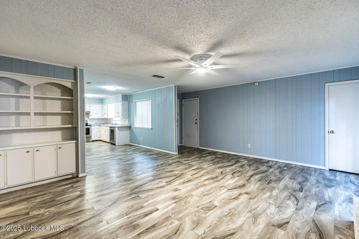 4305 52nd Street, Unit A Lubbock, TX 79413 - Photo 14 of 38 a view of an empty room with cabinet and a window