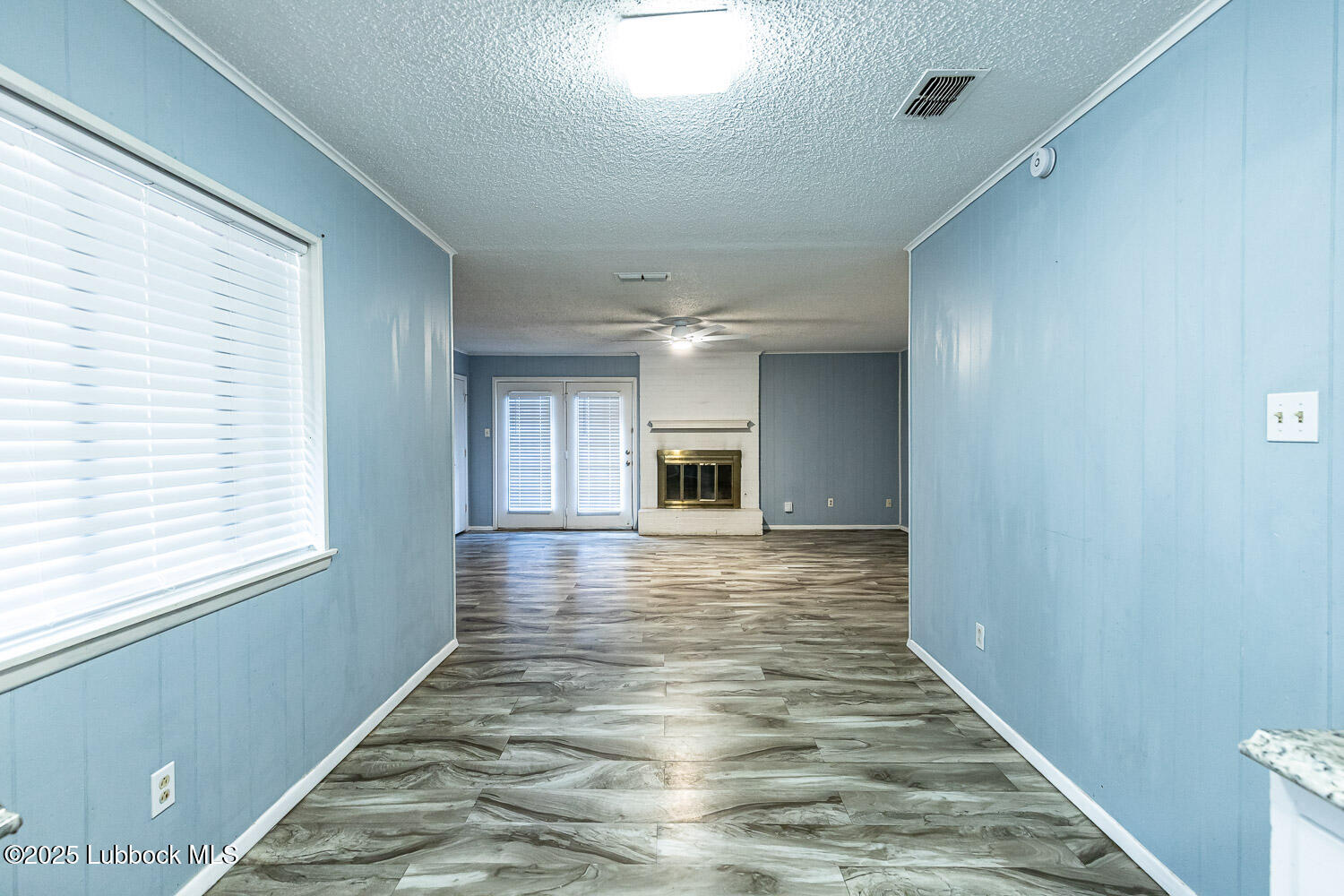 4305 52nd Street, Unit A Lubbock, TX 79413 - Photo 16 of 38 a view of a hallway with wooden floor and a window
