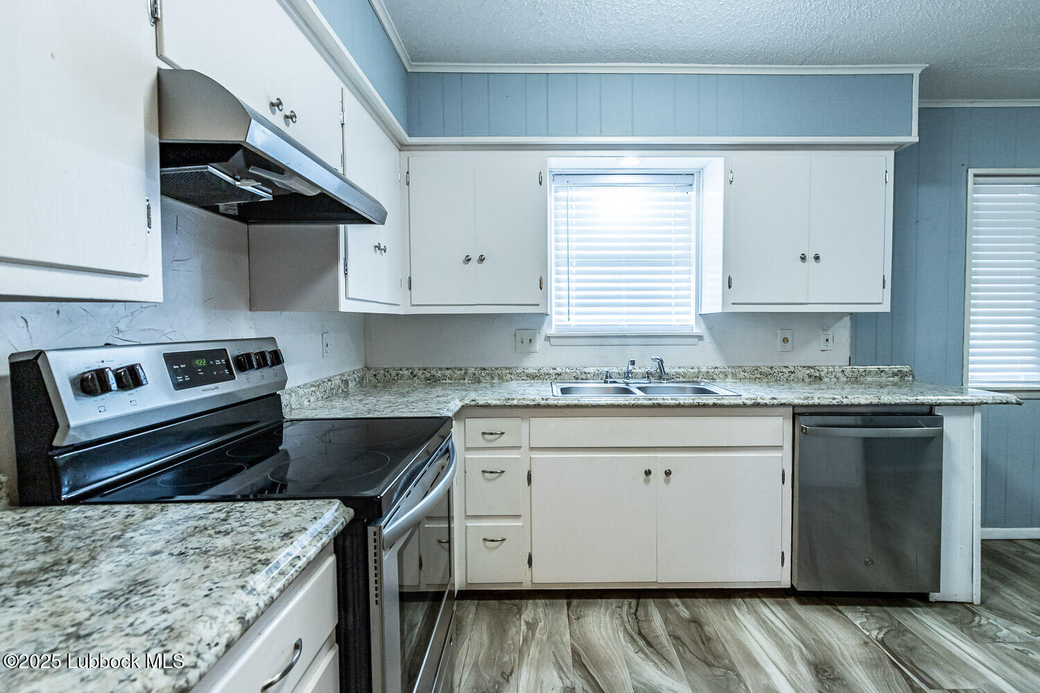 4305 52nd Street, Unit A Lubbock, TX 79413 - Photo 21 of 38 a kitchen with granite countertop stainless steel appliances sink stove and cabinets