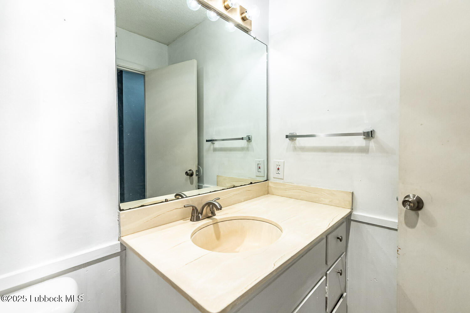 4305 52nd Street, Unit A Lubbock, TX 79413 - Photo 29 of 38 a bathroom with a sink and a mirror