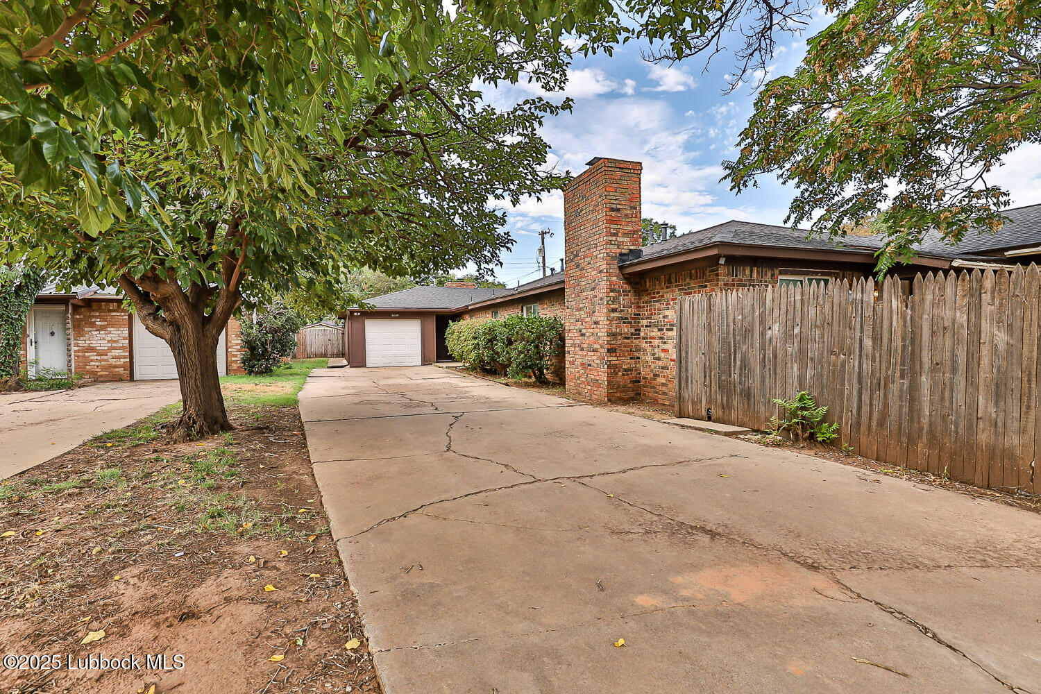 4305 52nd Street, Unit A Lubbock, TX 79413 - Photo 3 of 38 a front view of a house with a yard and garage