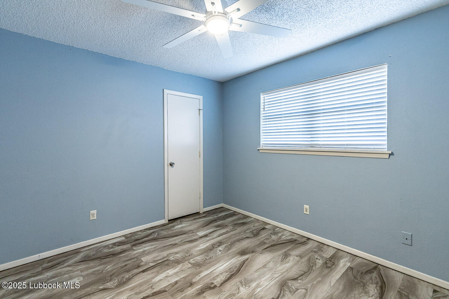 4305 52nd Street, Unit A Lubbock, TX 79413 - Photo 32 of 38 a view of a room with a ceiling fan and a window