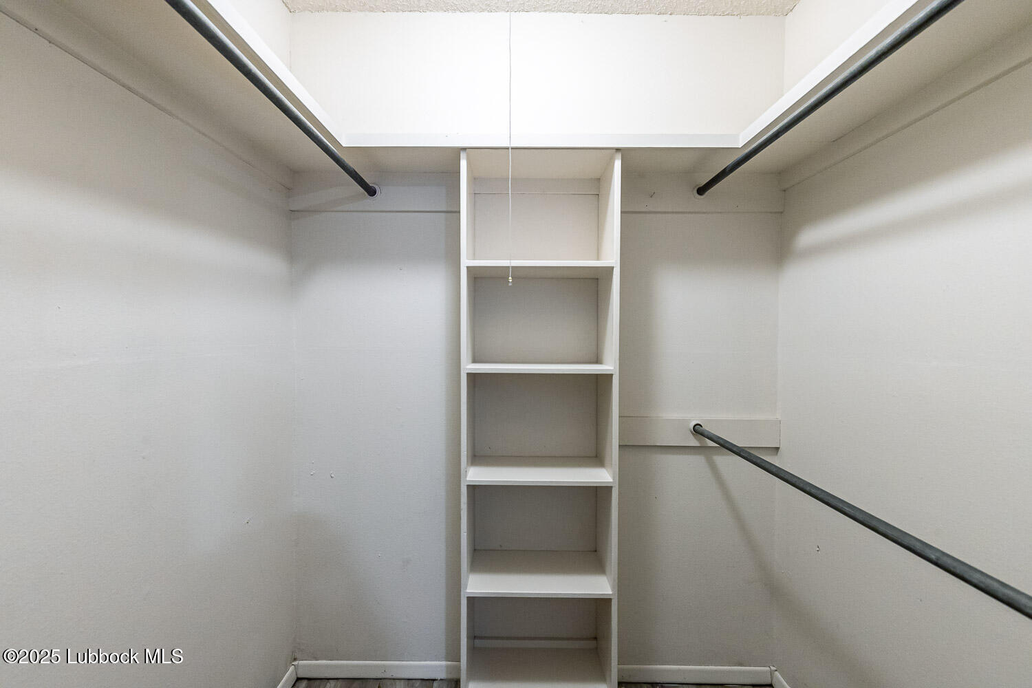 4305 52nd Street, Unit A Lubbock, TX 79413 - Photo 34 of 38 a view of walk in closet with empty racks