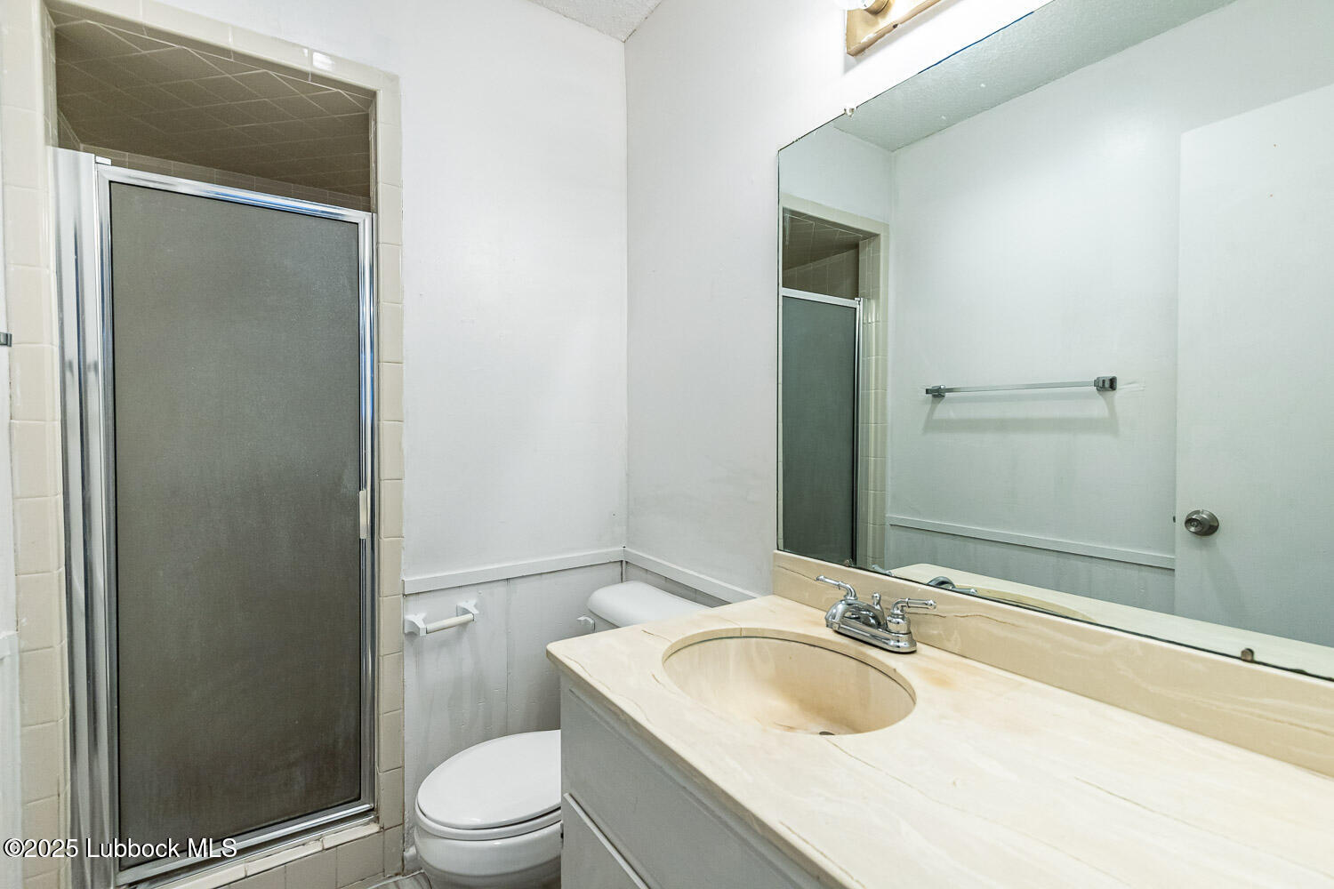 4305 52nd Street, Unit A Lubbock, TX 79413 - Photo 36 of 38 a bathroom with a granite countertop sink toilet and shower