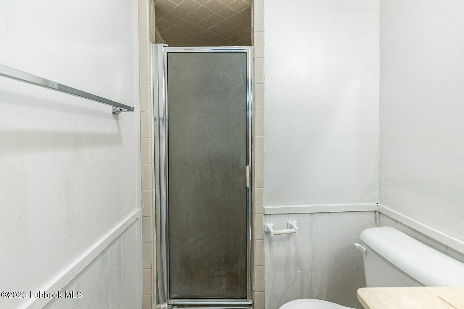 4305 52nd Street, Unit A Lubbock, TX 79413 - Photo 37 of 38 a white toilet sitting next to a shower