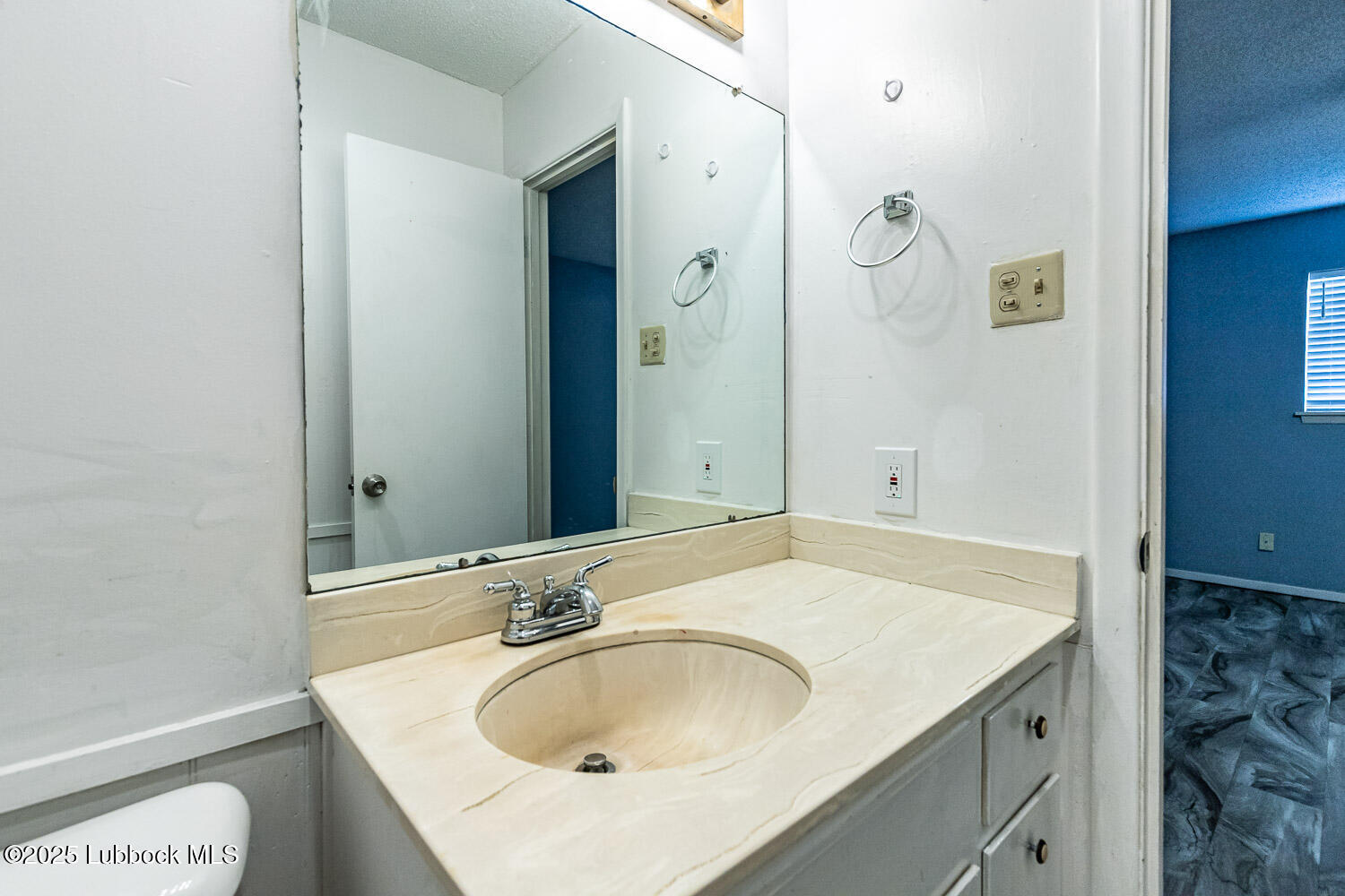 4305 52nd Street, Unit A Lubbock, TX 79413 - Photo 38 of 38 a bathroom with a sink and a mirror