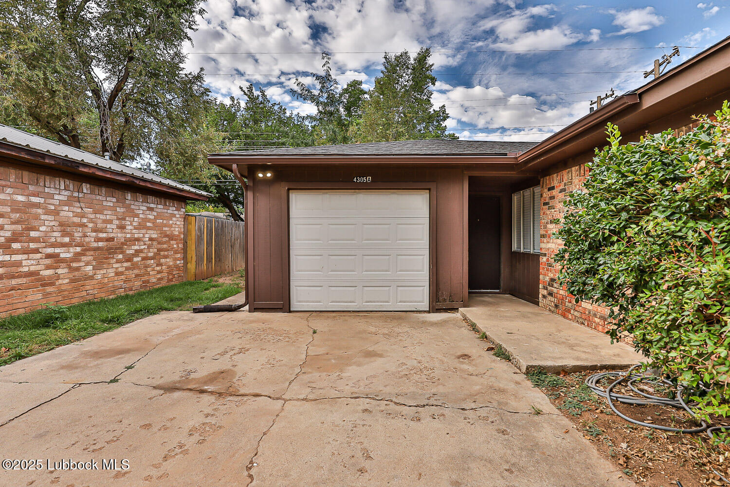 4305 52nd Street, Unit A Lubbock, TX 79413 - Photo 4 of 38 a front view of a house with a garden