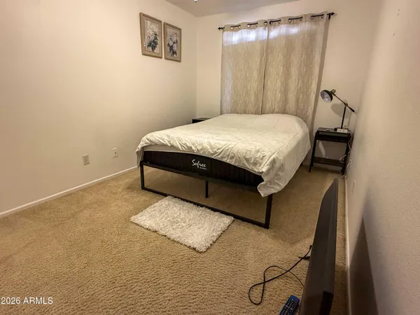a bed sitting in a bedroom next to a window
