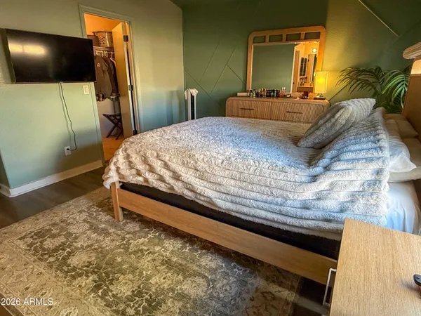 a bedroom with a bed and a mirror