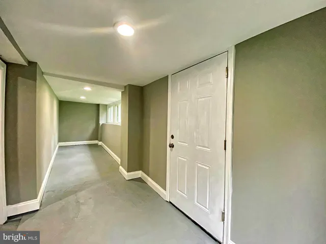 a view of a hallway with wooden floor and closet area