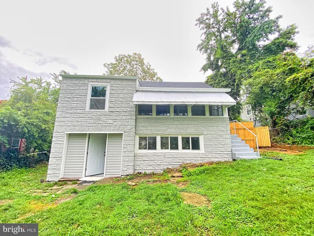 a view of a grassy field with trees in the background