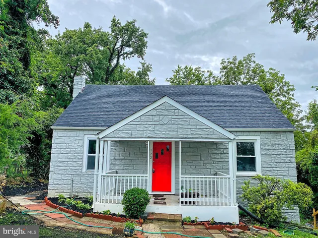 a view of a house with wooden fence