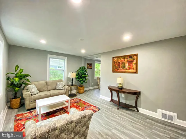 a living room with furniture and a potted plant