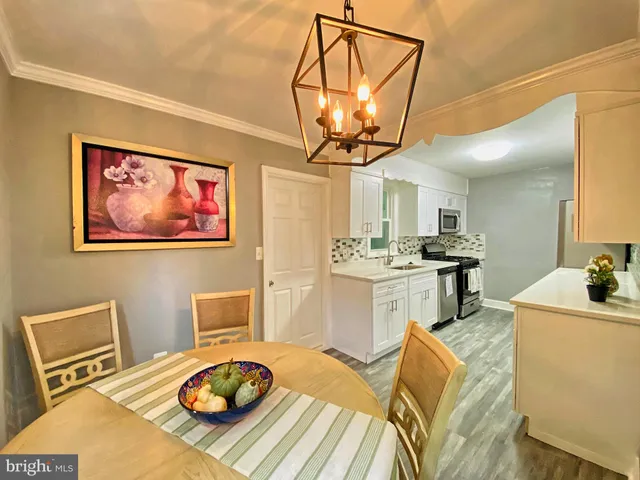 a living room with dining table and a table
