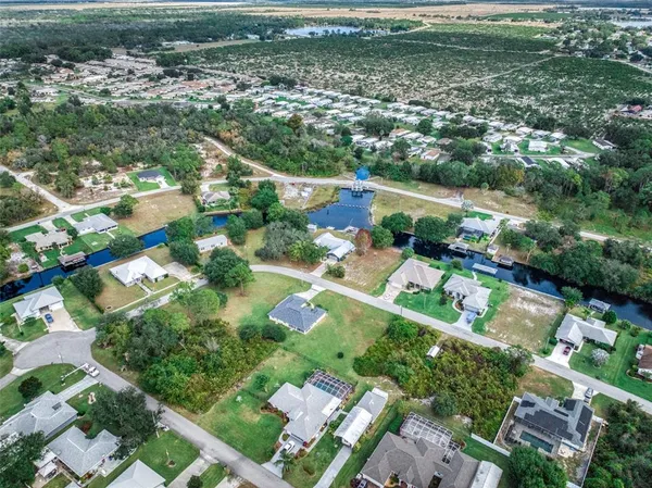 an aerial view of lake residential houses with outdoor space and swimming pool