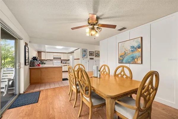 a dining room with furniture a window and wooden floor