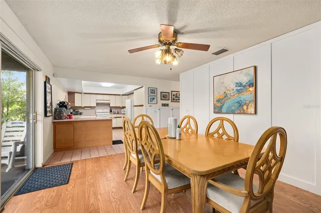 a view of a patio with a table chairs and a floor to ceiling window