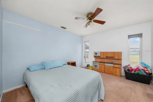 a bedroom with a bed dresser and a window