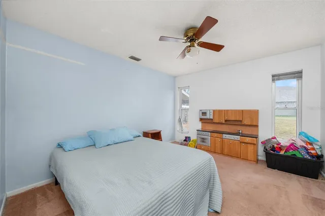 a view of a living room with furniture and floor to ceiling window