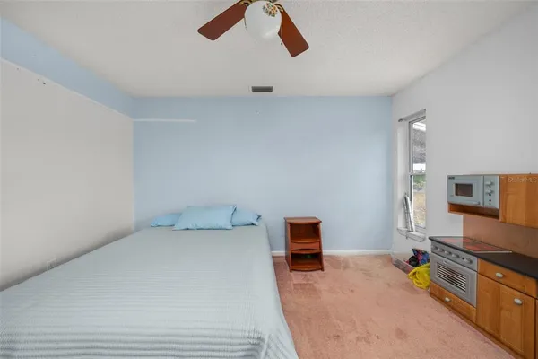 a bed room with a bed and a television