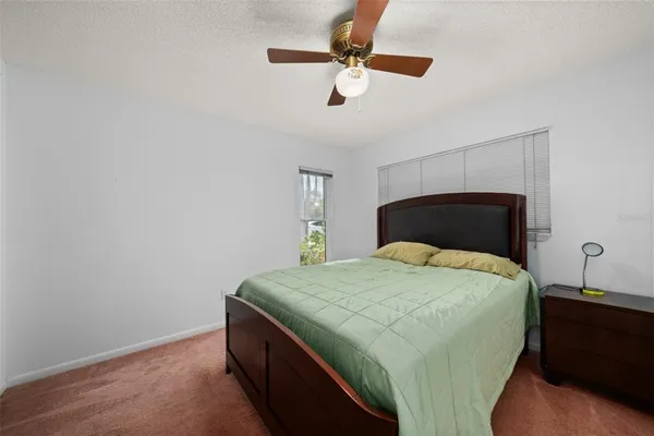 a bedroom with a bed and a cabinet