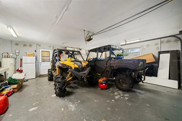 a kitchen that has a sink and white cabinets
