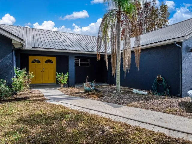 an aerial view of a house with a yard and garden