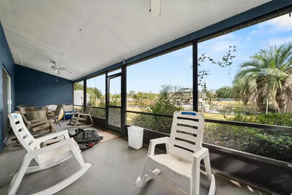 a view of a living room with furniture and floor to ceiling window