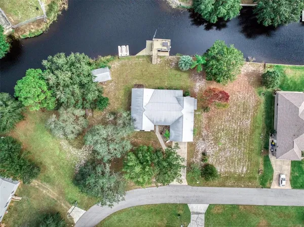 an aerial view of a house with a yard and garden