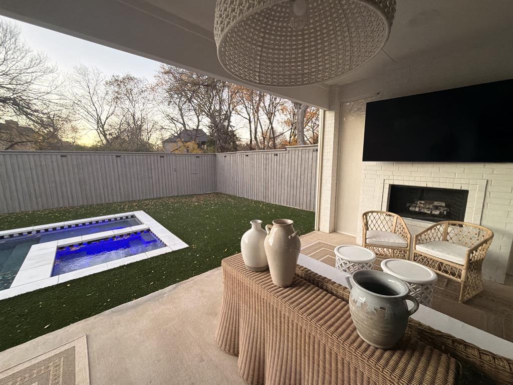7519 Taos Road Dallas, TX 75209 - Photo 2 of 40 Patio terrace at dusk with a patio, a fenced backyard, and an in-ground hot tub