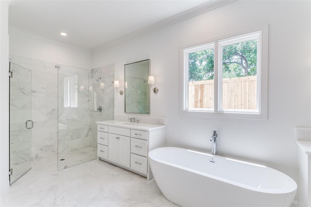 7519 Taos Road Dallas, TX 75209 - Photo 32 of 40 Full bathroom with a freestanding tub, vanity, a marble finish shower, ornamental molding, and light marble finish floors