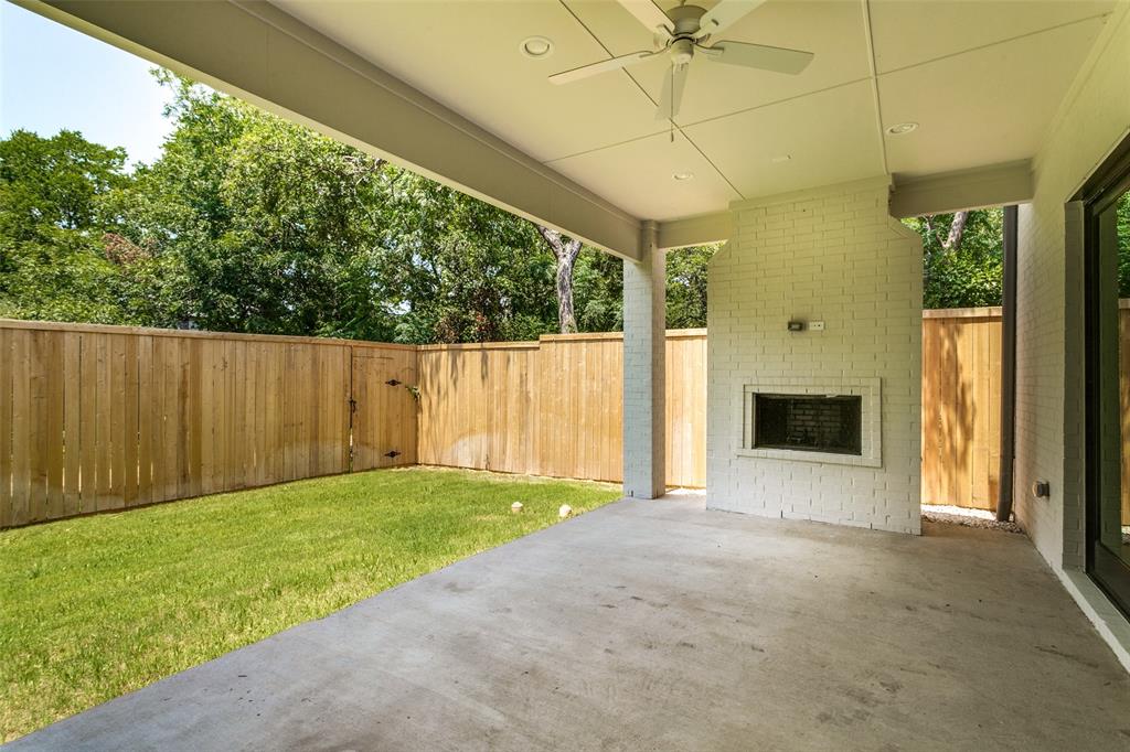 7519 Taos Road Dallas, TX 75209 - Photo 35 of 40 Fenced backyard with a ceiling fan, a patio, and an outdoor brick fireplace
