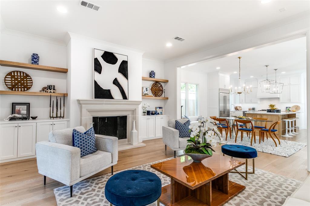 7519 Taos Road Dallas, TX 75209 - Photo 4 of 40 Living area with crown molding, a chandelier, a fireplace with raised hearth, light wood finished floors, and recessed lighting